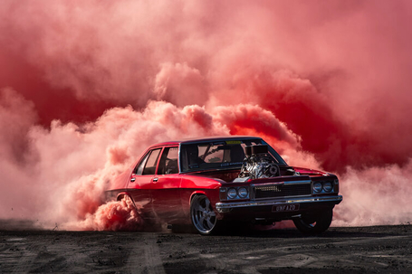 Vintage hot-rod car in a cloud of coloured smoke at Rocky Nats Festival Easter in Rockhampton