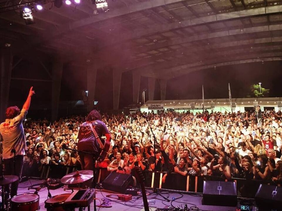 Big crowd of people experiencing live music event at iconic local hotel