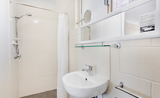 A compact 1990's retro-style bathroom add a nostalgic touch